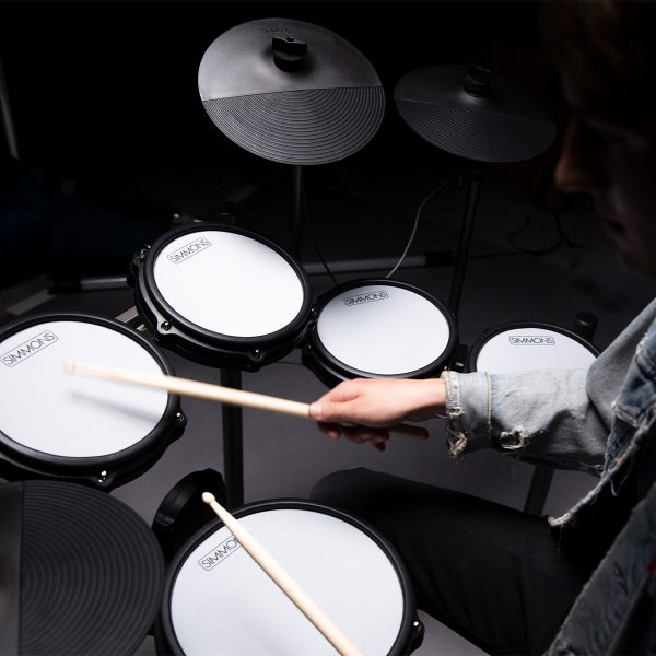 drummer playing the Titan 50 electronic drum kit in dark room