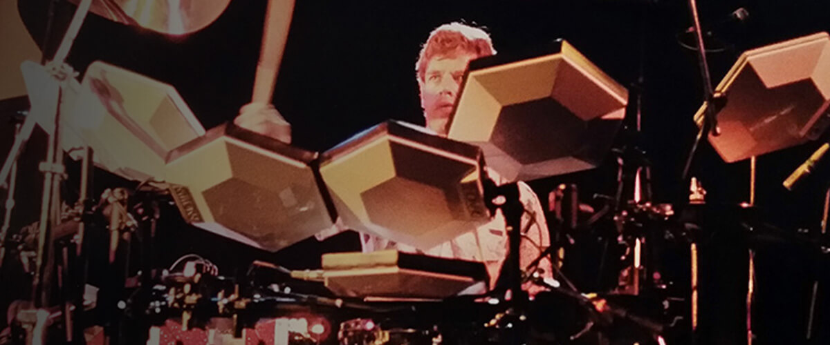 man playing vintage simmons drum kit