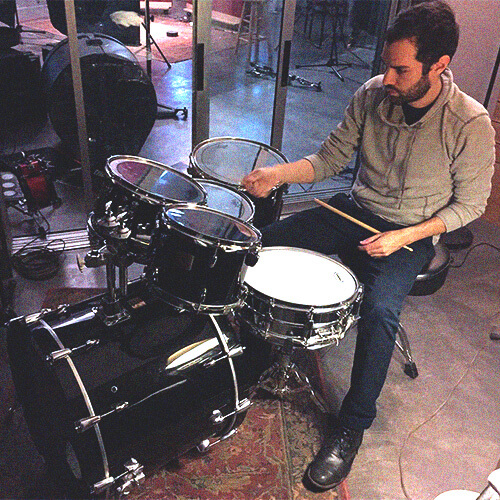 man playing studio birch drum kit