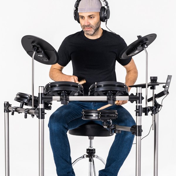 Drummer playing Simmons Titan 50 electronic drum kit with headphones