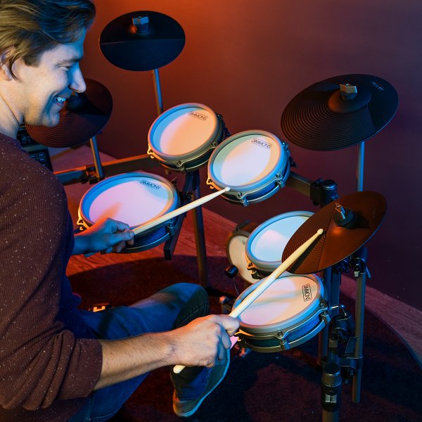image of drummer smiling while playing the simmons titan 70 electronic drum kit